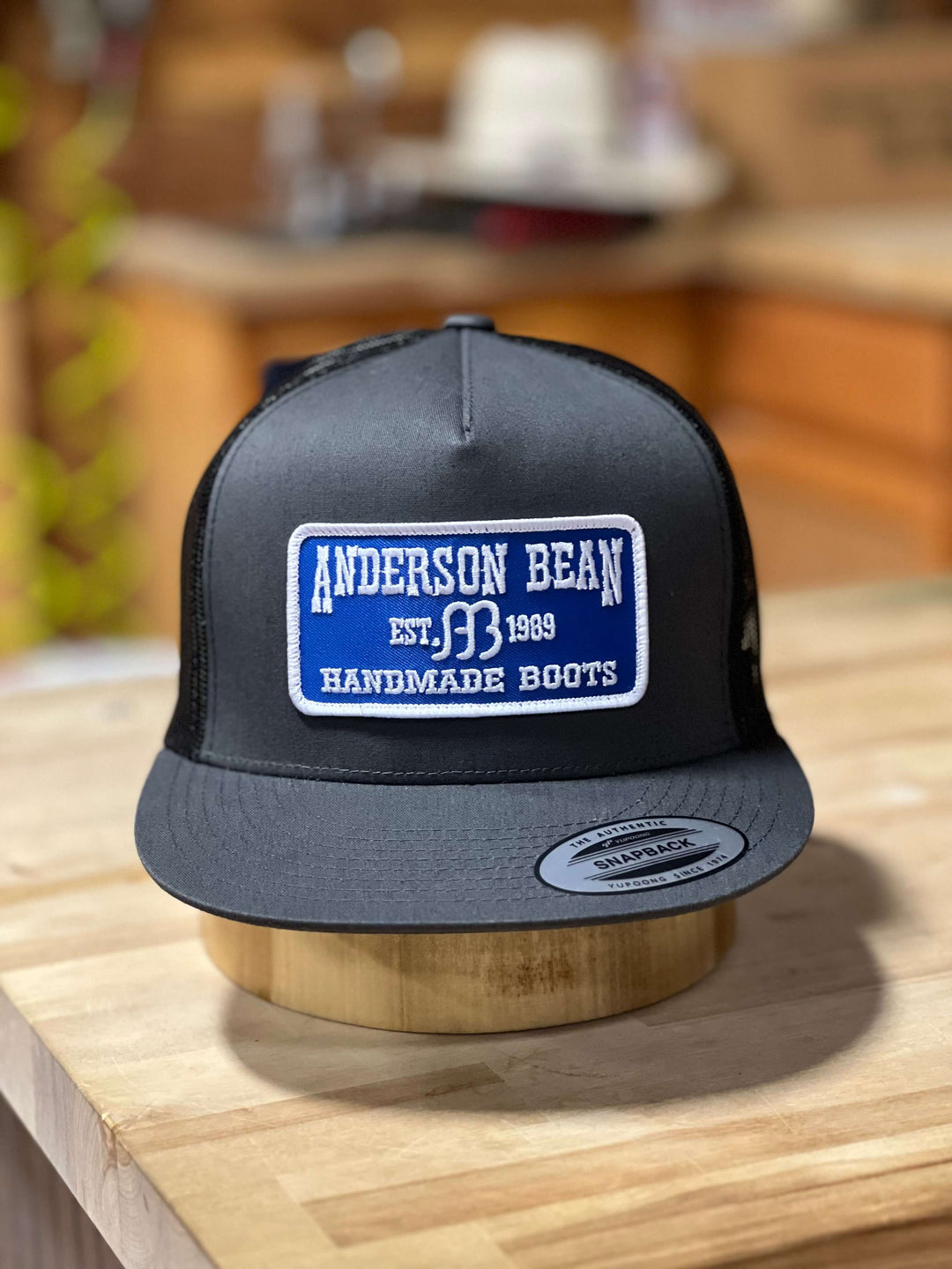 Anderson Bean Handmade Boots snapback hat, black front, black mesh, blue and white logo 